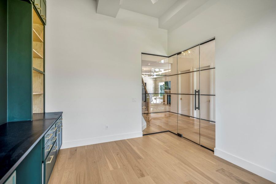 This beautiful office is enclosed with a modern glass enclosure with sleek design to provide the privacy for calls and meetings but open and see through to watch the kids play in the living room. This beautiful office is enclosed with a modern glass enclosure with sleek design to provide the privacy for calls and meetings but open and see through to watch the kids play in the living room.