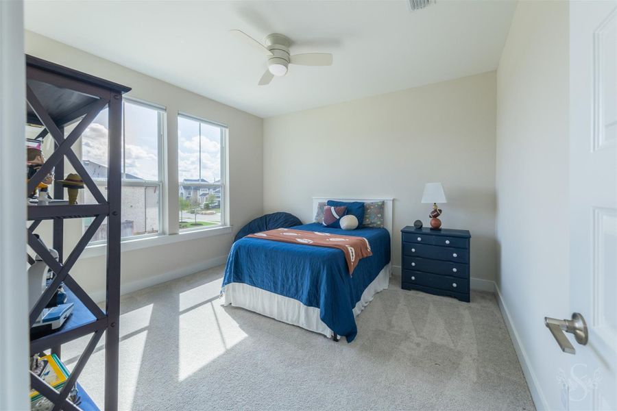 Bright upstairs bedroom offers plenty of space for younger family members, with oversized windows bringing in beautiful sunlight. Soft neutral finishes and plush carpeting create a comfortable, inviting retreat. Bright upstairs bedroom offers plenty of space for younger family members, with oversized windows bringing in beautiful sunlight. Soft neutral finishes and plush carpeting create a comfortable, inviting retreat.
