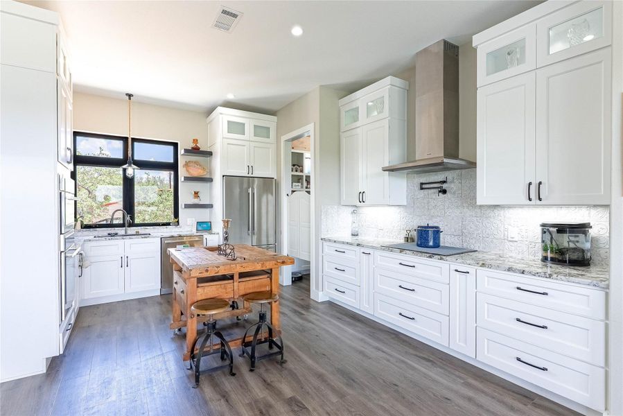 Gourmet kitchen with Thermador appliances and oversized pantry.
