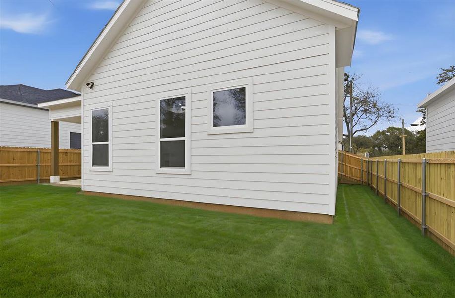 Back of house featuring a fenced backyard