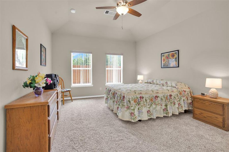 Master bedroom with windows viewing the back yard