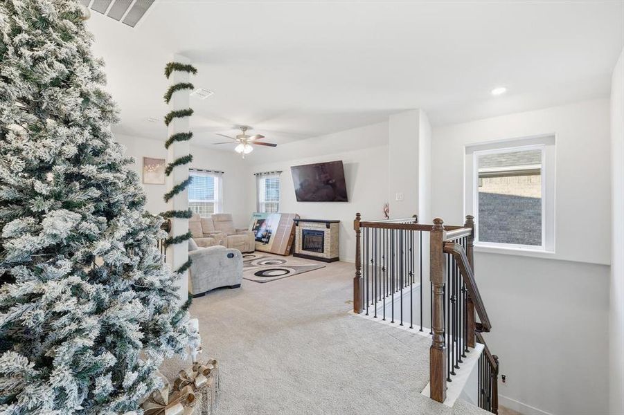 Living room with carpet, a ceiling fan, and recessed lighting