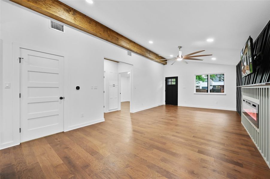 Unfurnished living room with ceiling fan, wood finished floors, recessed lighting, and baseboards