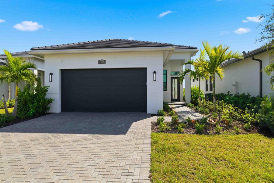 Front exterior of a new home in , Port St. Lucie, FL, highlighting curb appeal (Image 2).