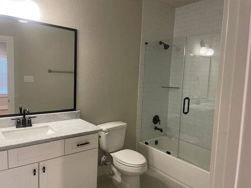 Secondary bathroom with glass shower doors