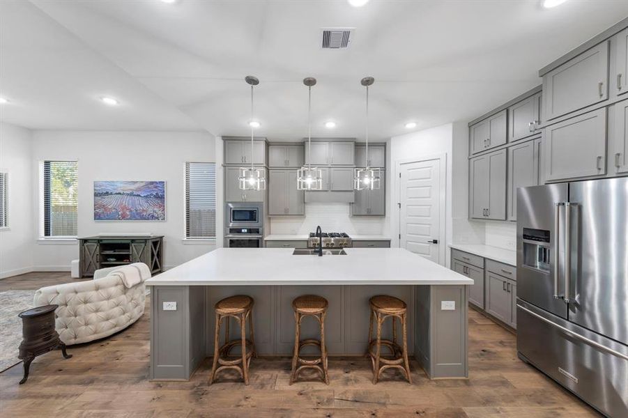 The kitchen is equipped with luxurious stainless steel appliances and a spacious walk-in pantry, providing both elegance and ample storage for all your culinary needs.