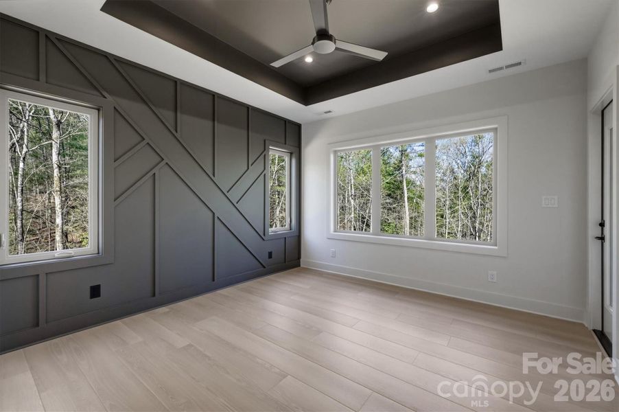 The owners' suite has a magnificent feature wall. There is a Minka-Aire ceiling fan and a exquisite tray ceiling, and of course, lots of large windows to let the natural light inside. The owners' suite has a magnificent feature wall. There is a Minka-Aire ceiling fan and a exquisite tray ceiling, and of course, lots of large windows to let the natural light inside.