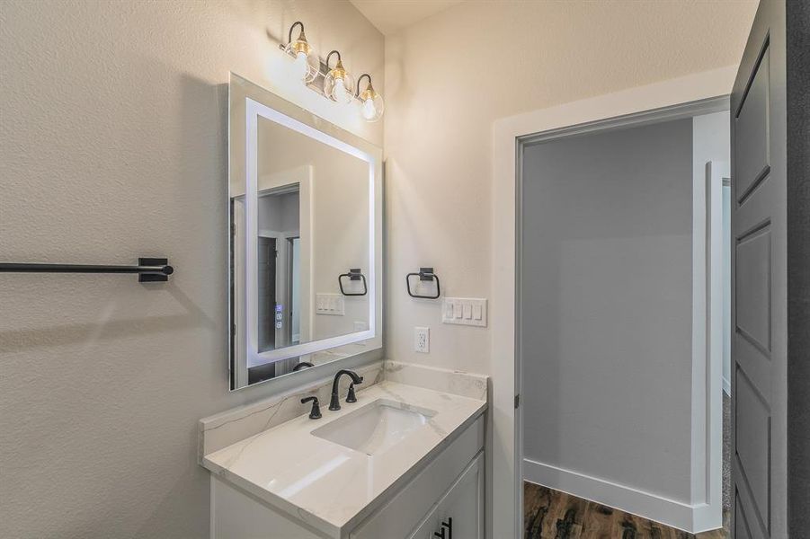 Bathroom with hardwood / wood-style floors and vanity