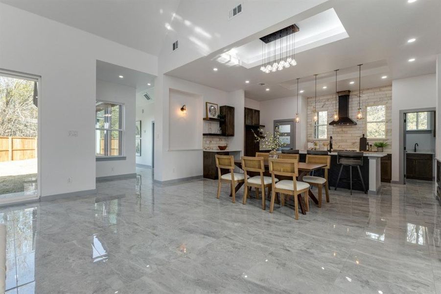 Dining room featuring a high ceiling and sink