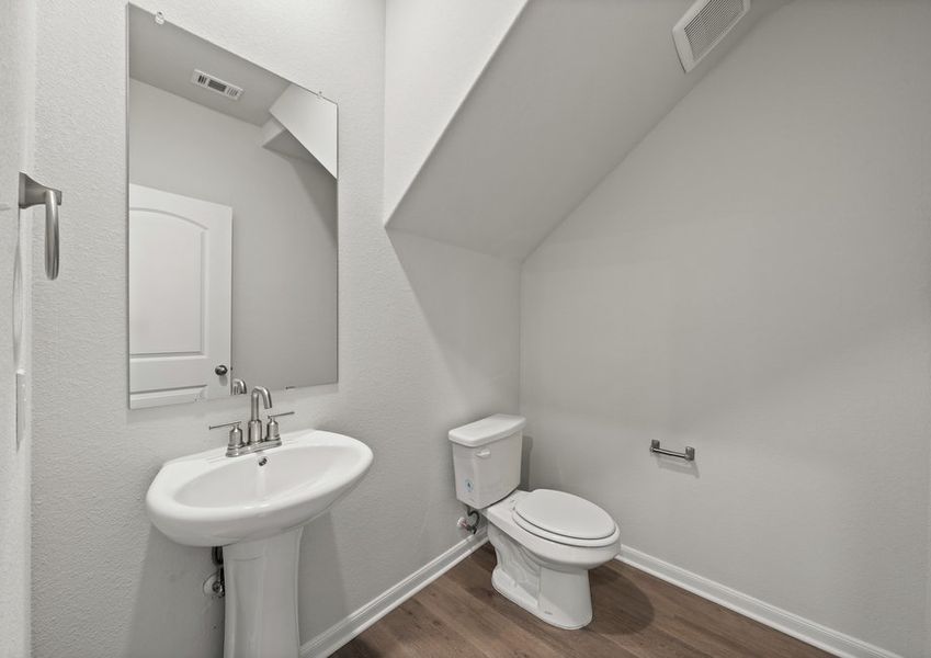 The downstairs powder room provides convenience for family and guests. The downstairs powder room provides convenience for family and guests.