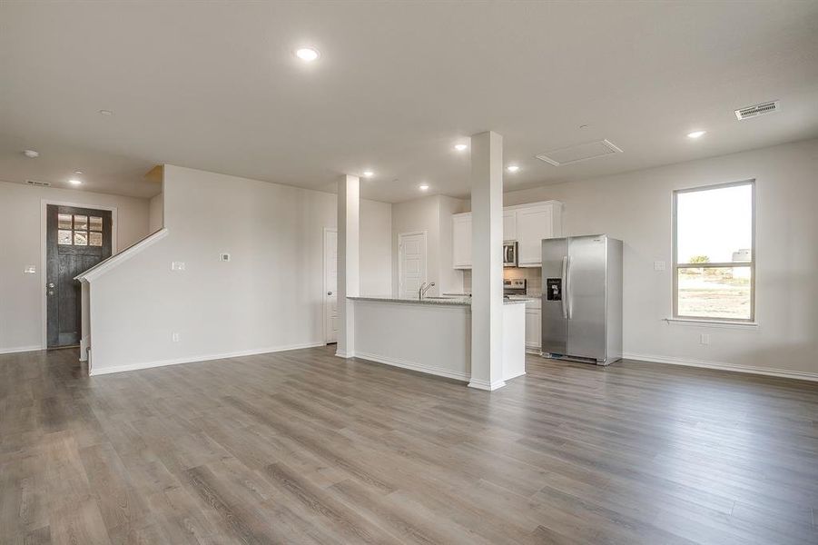 Unfurnished living room with recessed lighting and light wood-type flooring