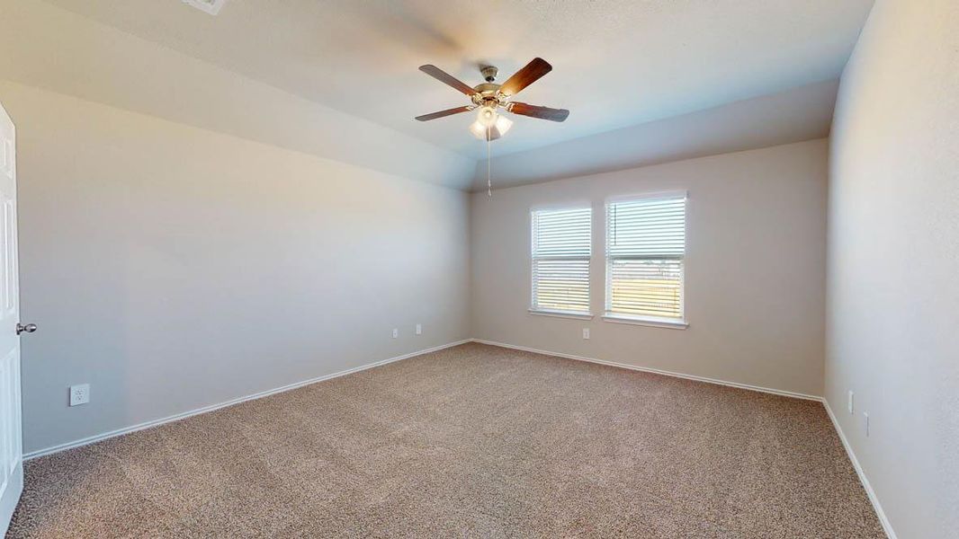 Unfurnished room with light colored carpet, ceiling fan, and vaulted ceiling