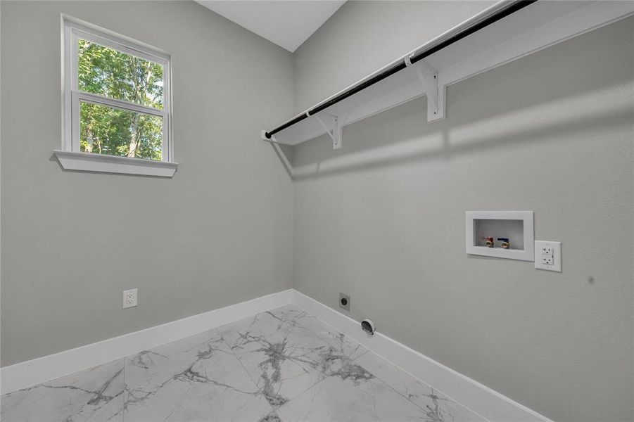 Clothes washing area with hookup for an electric dryer, tile patterned flooring, washer hookup, and hookup for a gas dryer