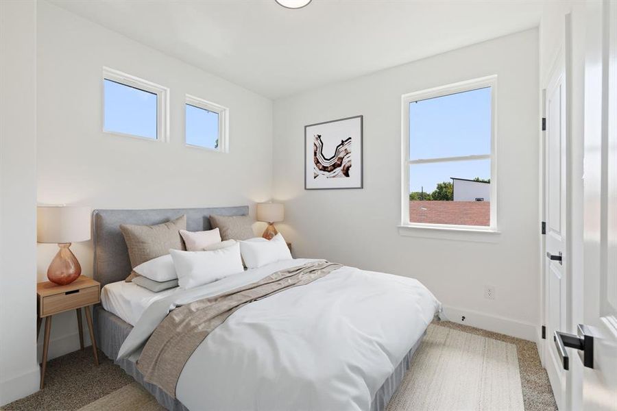 Bedroom featuring light colored carpet and baseboards