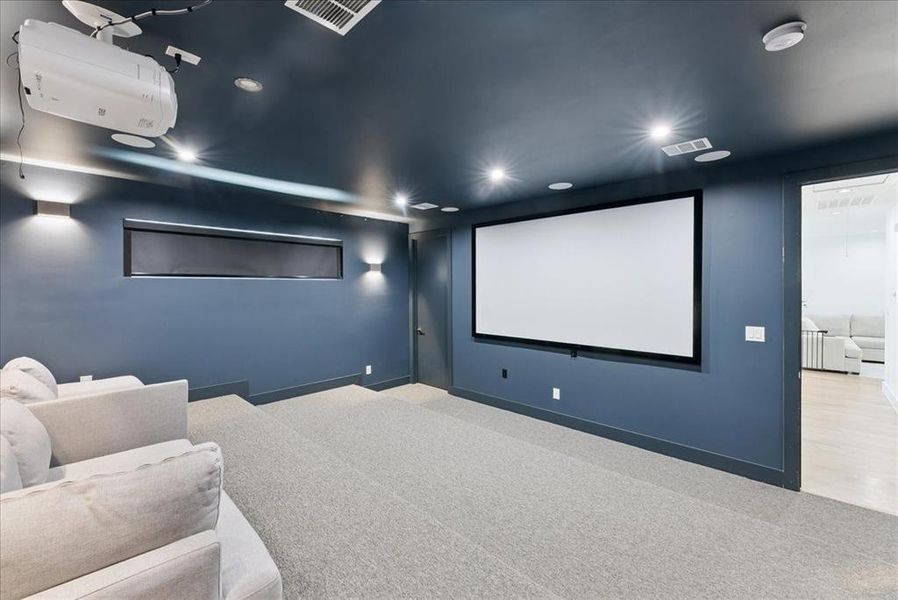 Carpeted cinema room featuring baseboards and recessed lighting