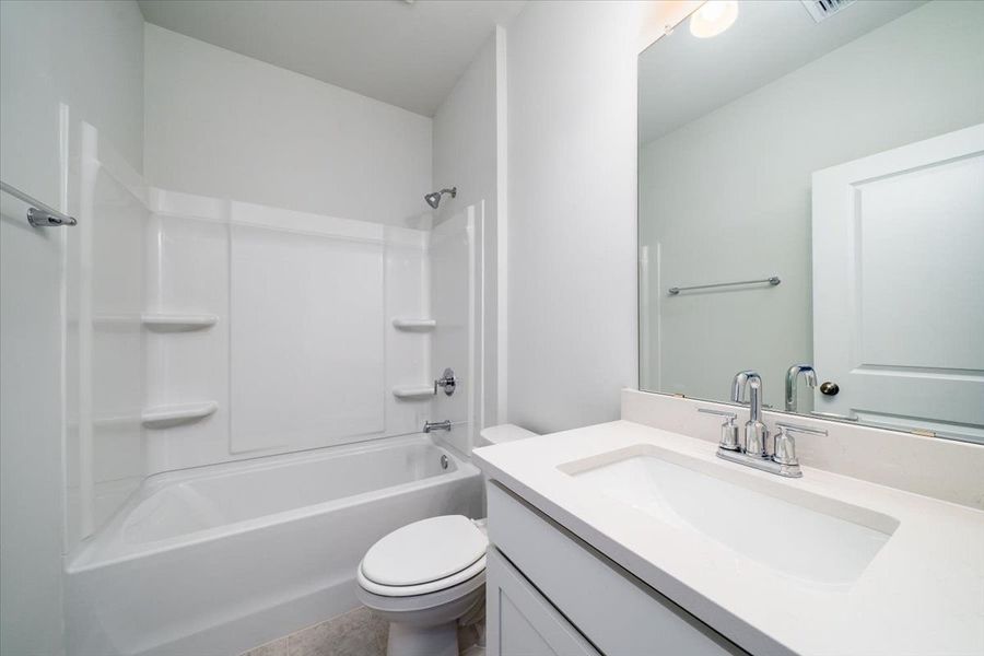 Secondary bathroom with a shower and tub. Secondary bathroom with a shower and tub.