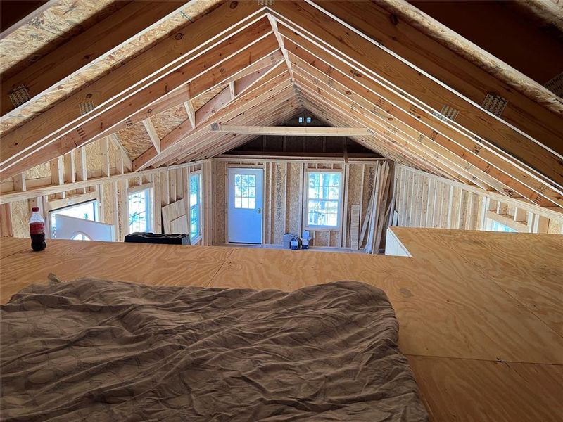 Unfurnished bedroom with vaulted ceiling