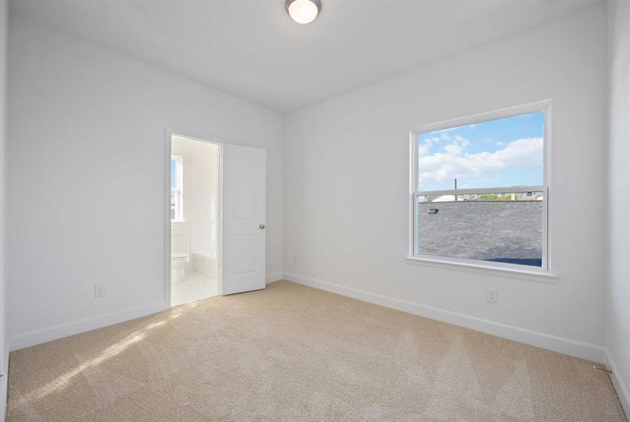 A perfect retreat, this secondary bedroom offers ample space and neutral finishes, ready to be personalized.