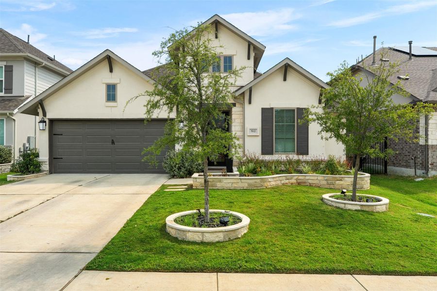 Front exterior of a new home in Santa Rita Ranch 50', Liberty Hill, TX, highlighting curb appeal (Image 19). Front exterior of a new home in Santa Rita Ranch 50', Liberty Hill, TX, highlighting curb appeal (Image 19).