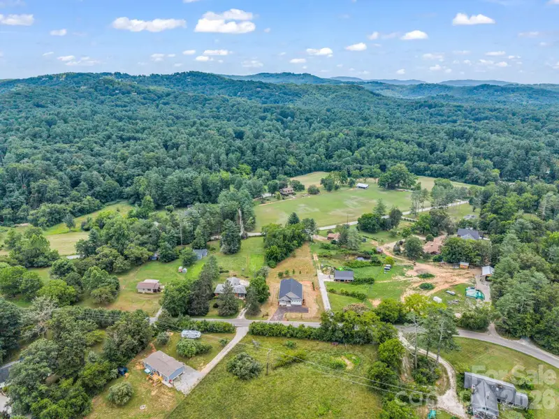 Aerial view of the front of the home showing both access roads. Perfect for another driveway for RV, shop or garage. Aerial view of the front of the home showing both access roads. Perfect for another driveway for RV, shop or garage.