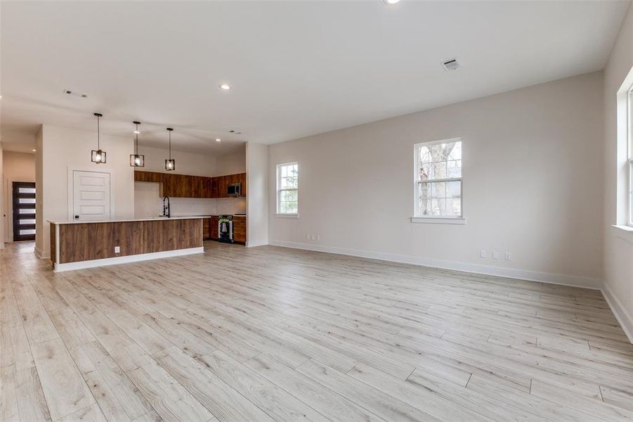 Unfurnished living room with visible vents, recessed lighting, baseboards, and light wood-type flooring