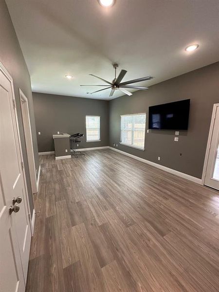 Unfurnished living room featuring dark wood finished floors, recessed lighting, and ceiling fan
