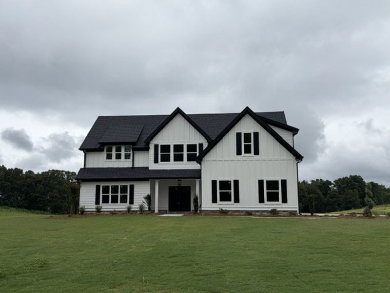 Front exterior of a new home in Blackwelder Bluff, Bowdon, GA, highlighting curb appeal (Image 1). Front exterior of a new home in Blackwelder Bluff, Bowdon, GA, highlighting curb appeal (Image 1).