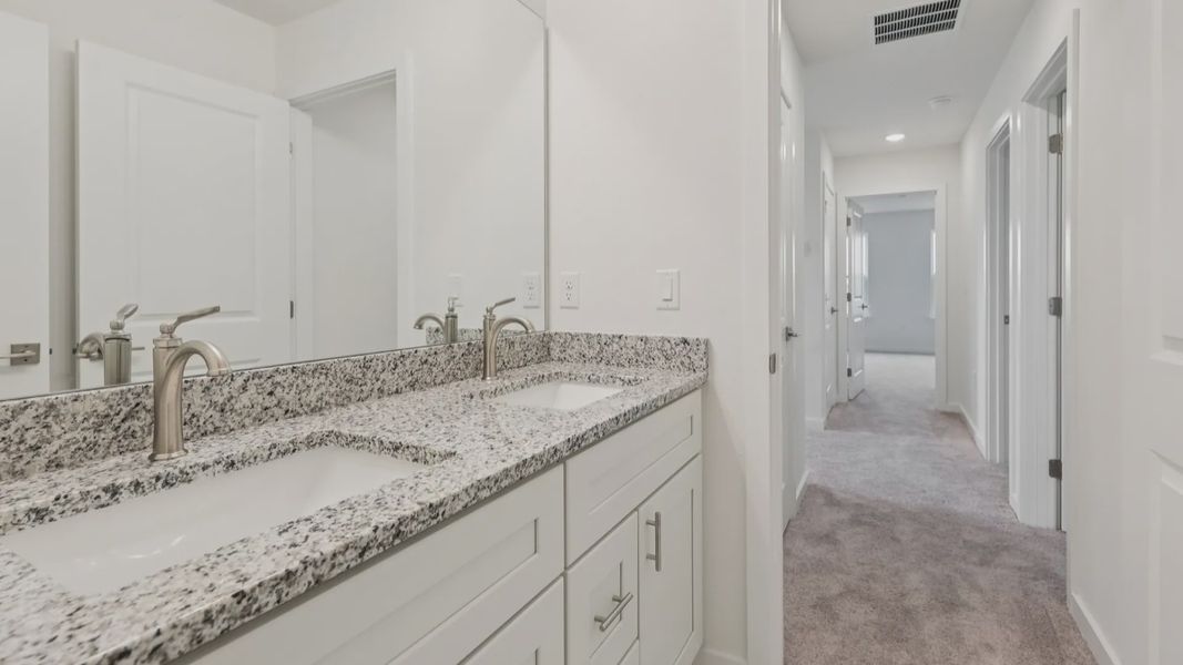 Secondary Bathroom with Dual Sink Vanity in the Naples Floor Plan by DRB Homes Secondary Bathroom with Dual Sink Vanity in the Naples Floor Plan by DRB Homes