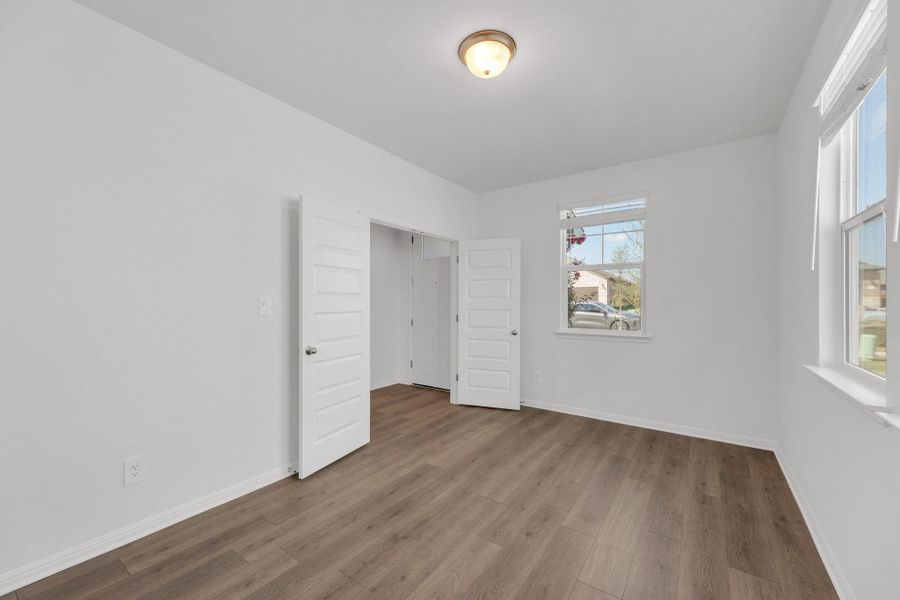 Unfurnished bedroom featuring wood finished floors Unfurnished bedroom featuring wood finished floors