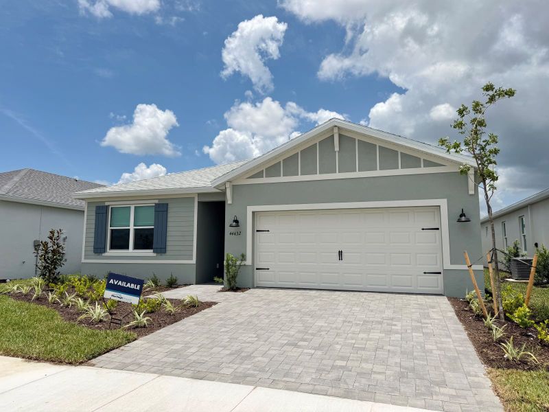 Front exterior of a new home in Crescent Lakes - Reserve Series, Punta Gorda, FL, highlighting curb appeal (Image 2). Front exterior of a new home in Crescent Lakes - Reserve Series, Punta Gorda, FL, highlighting curb appeal (Image 2).