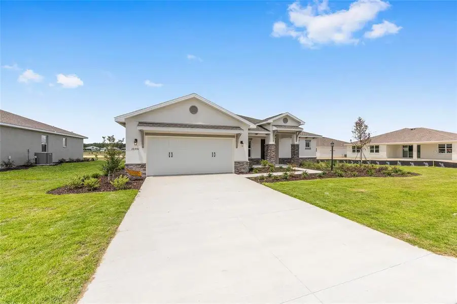 Front exterior of a new home in , Ocala, FL, highlighting curb appeal (Image 2). Front exterior of a new home in , Ocala, FL, highlighting curb appeal (Image 2).