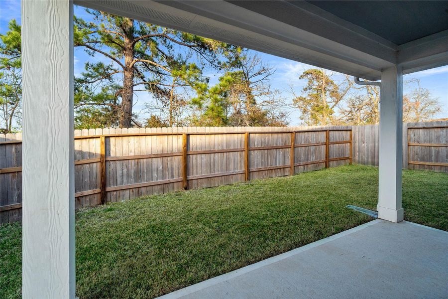 Enjoy the outdoors! A covered patio with integrated recessed lighting offers a space for entertaining guests or relaxing.