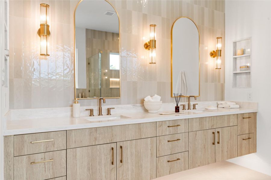 Twin arched mirrors and a floor-to-ceiling tile accent wall turn the everyday task of getting ready into something that actually feels good. The double vanity means no more waiting your turn.