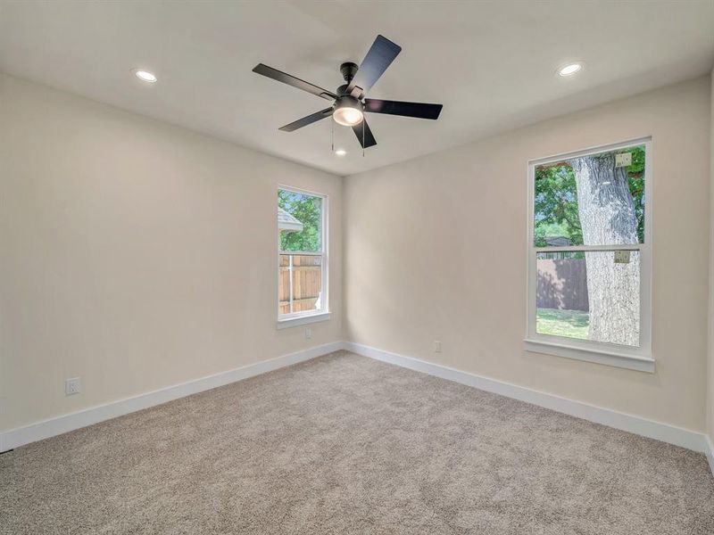 Empty room with carpet flooring and ceiling fan