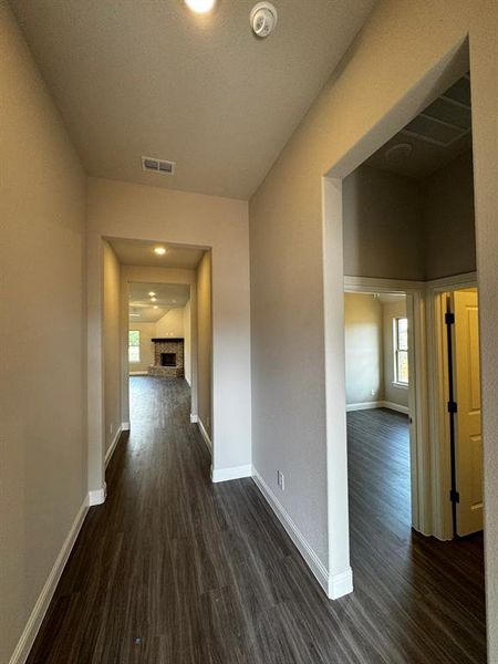 Hallway with dark hardwood / wood-style floors