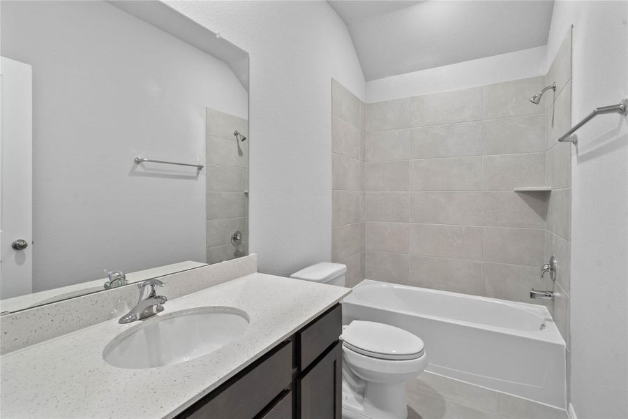 A streamlined secondary bathroom providing a functional tub/shower combination and modern fixtures, seamlessly blending practicality and style.