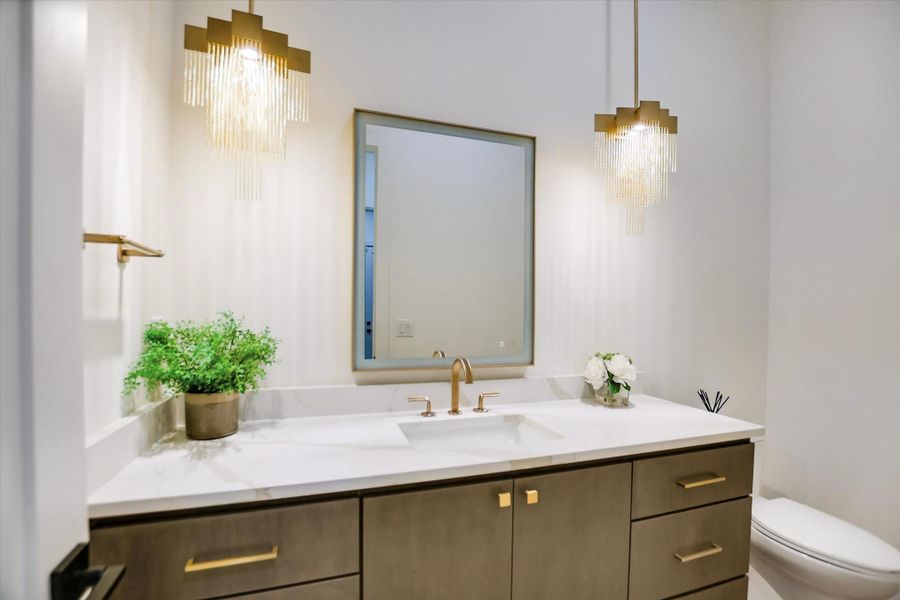 Elegant gold-tone fixtures complement a spacious vanity with clean lines.