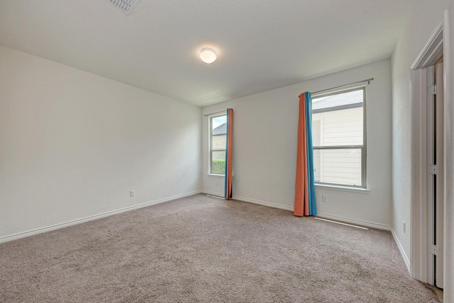 A quiet, neutrally toned space with generous windows, perfect for personalized design.