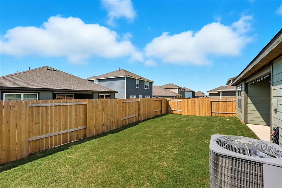 Fenced backyard with a residential view