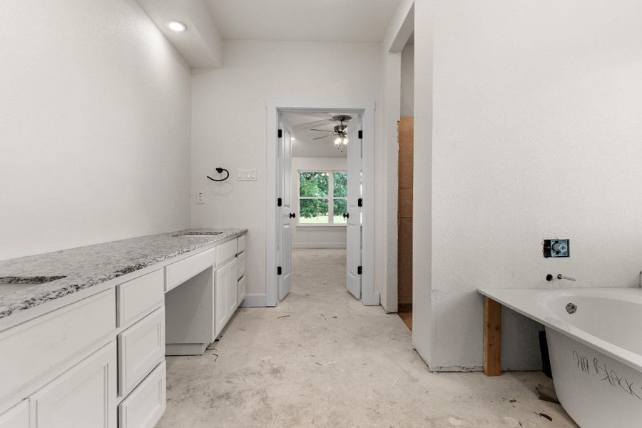 Full bath featuring a freestanding bath and ceiling fan Full bath featuring a freestanding bath and ceiling fan