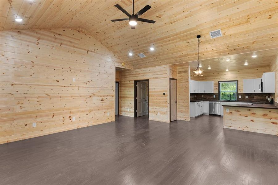 Kitchen with dark countertops, dishwasher, visible vents, wood ceiling, and high vaulted ceiling Kitchen with dark countertops, dishwasher, visible vents, wood ceiling, and high vaulted ceiling