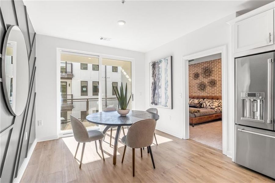 The dining area is filled with sunlight from the balcony.*Images from the model home. Not subject unit*