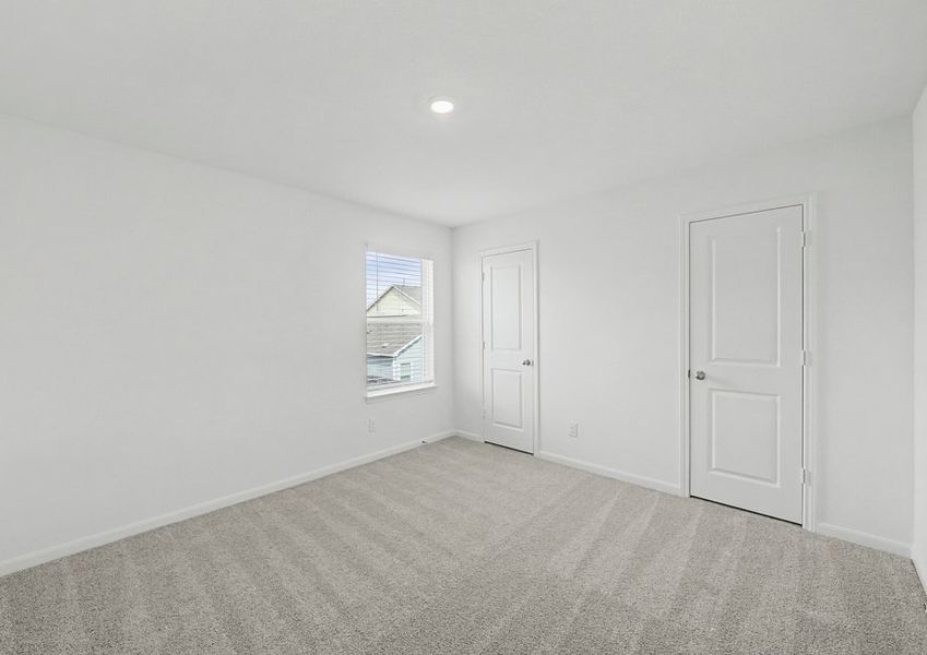 Secondary bedroom with a window and recessed lighting.