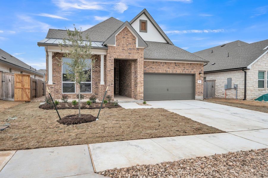 View of front of home featuring a garage, driveway, brick siding, and roof with shingles View of front of home featuring a garage, driveway, brick siding, and roof with shingles