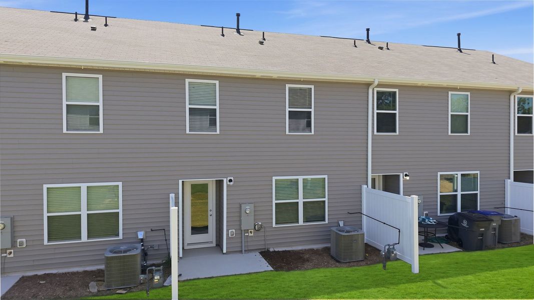 Exterior details and patio area of a home in The Townes at Hunter Hill, Rocky Mount (Image 18).
