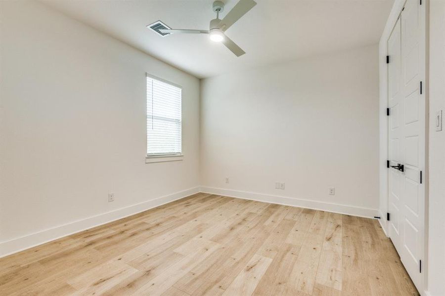 Unfurnished room with light hardwood / wood-style flooring and ceiling fan