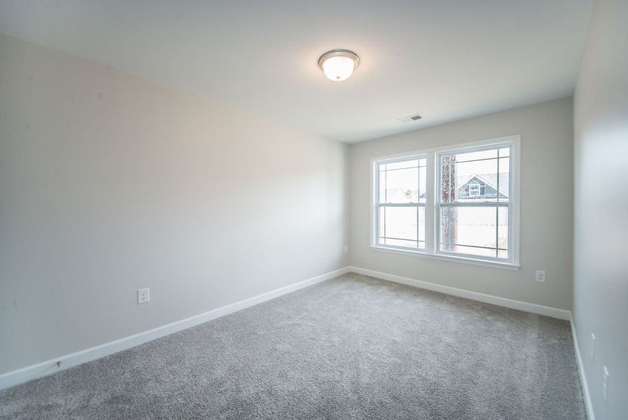 Representative unfurnished interior of a home built from the Quincy by Enchanted Homes in Hampshire Heights, Moore (Image 23).
