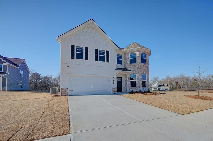 Front exterior of a new home in Chapel Hill, Newnan, GA, highlighting curb appeal (Image 1). Front exterior of a new home in Chapel Hill, Newnan, GA, highlighting curb appeal (Image 1).