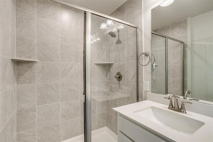 Full bathroom featuring vanity and a shower stall