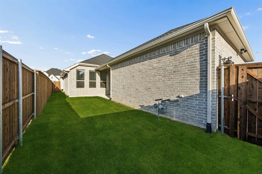 Exterior details and patio area of a home in Cambridge Crossing, Celina (Image 26).